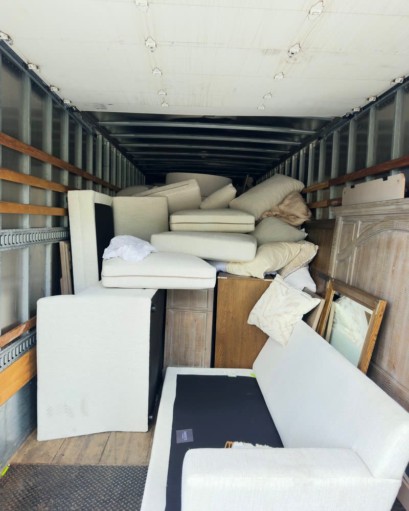 Box truck loaded tier by tier with furniture and cushions
