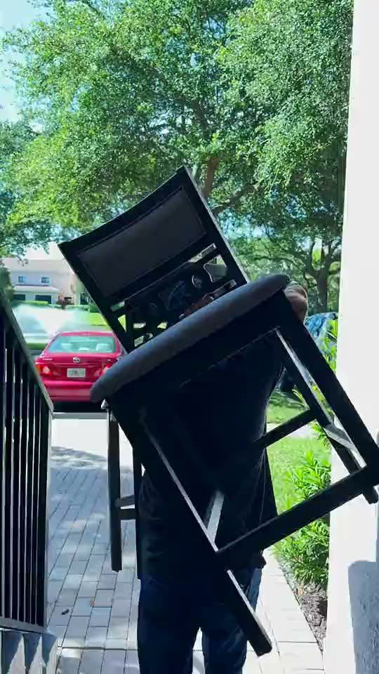 Mover carrying a chair out to the truck