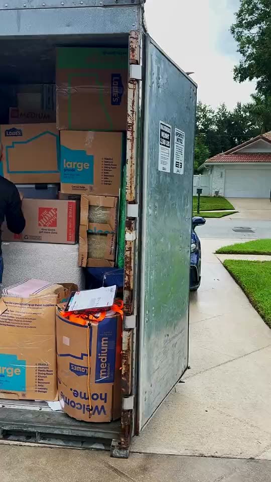 Mover stacking boxes inside a moving container