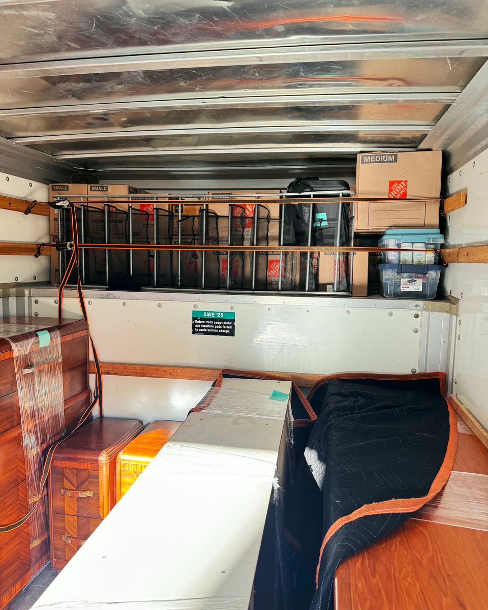 Rental truck loaded with wrapped mattresses and furniture