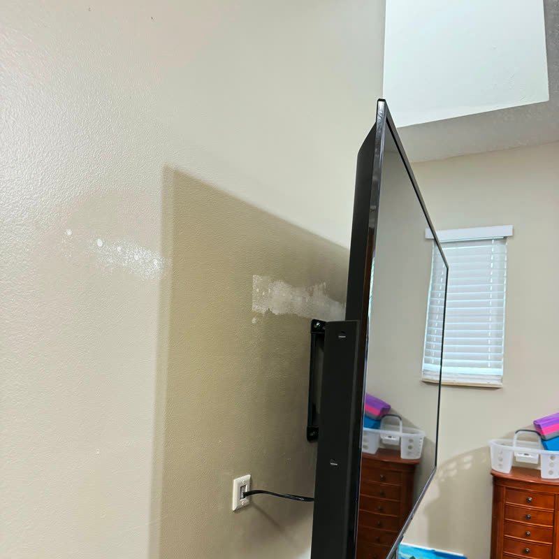Mounted TV seen from the side, close to the wall