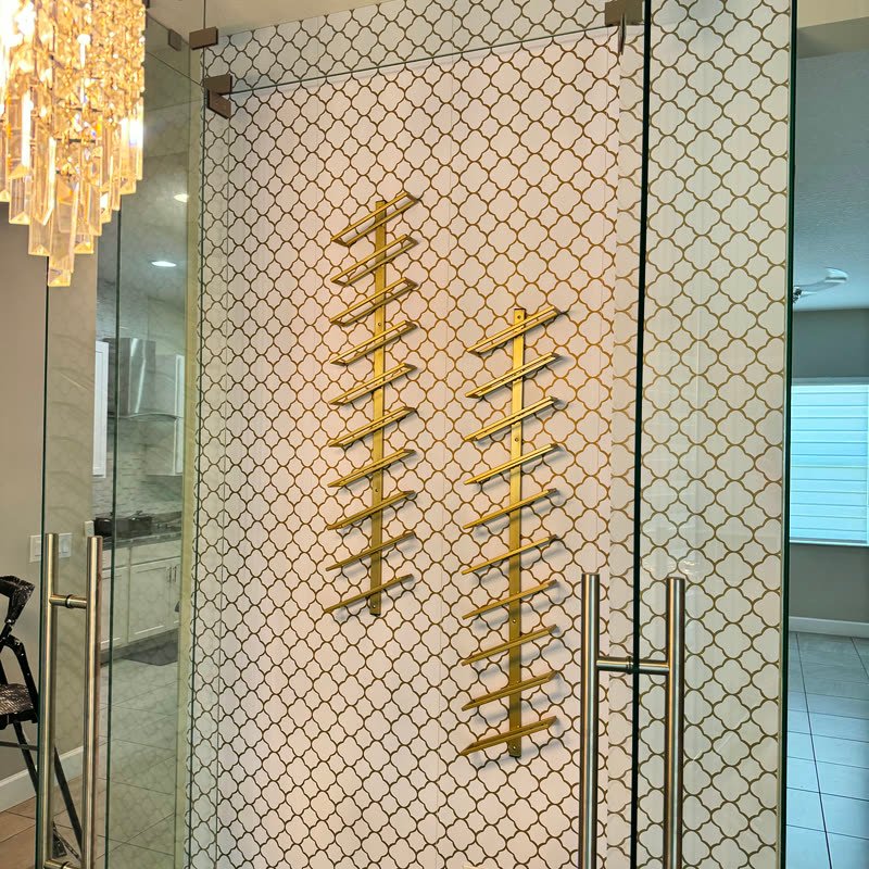 Gold wine racks mounted on a tiled wall